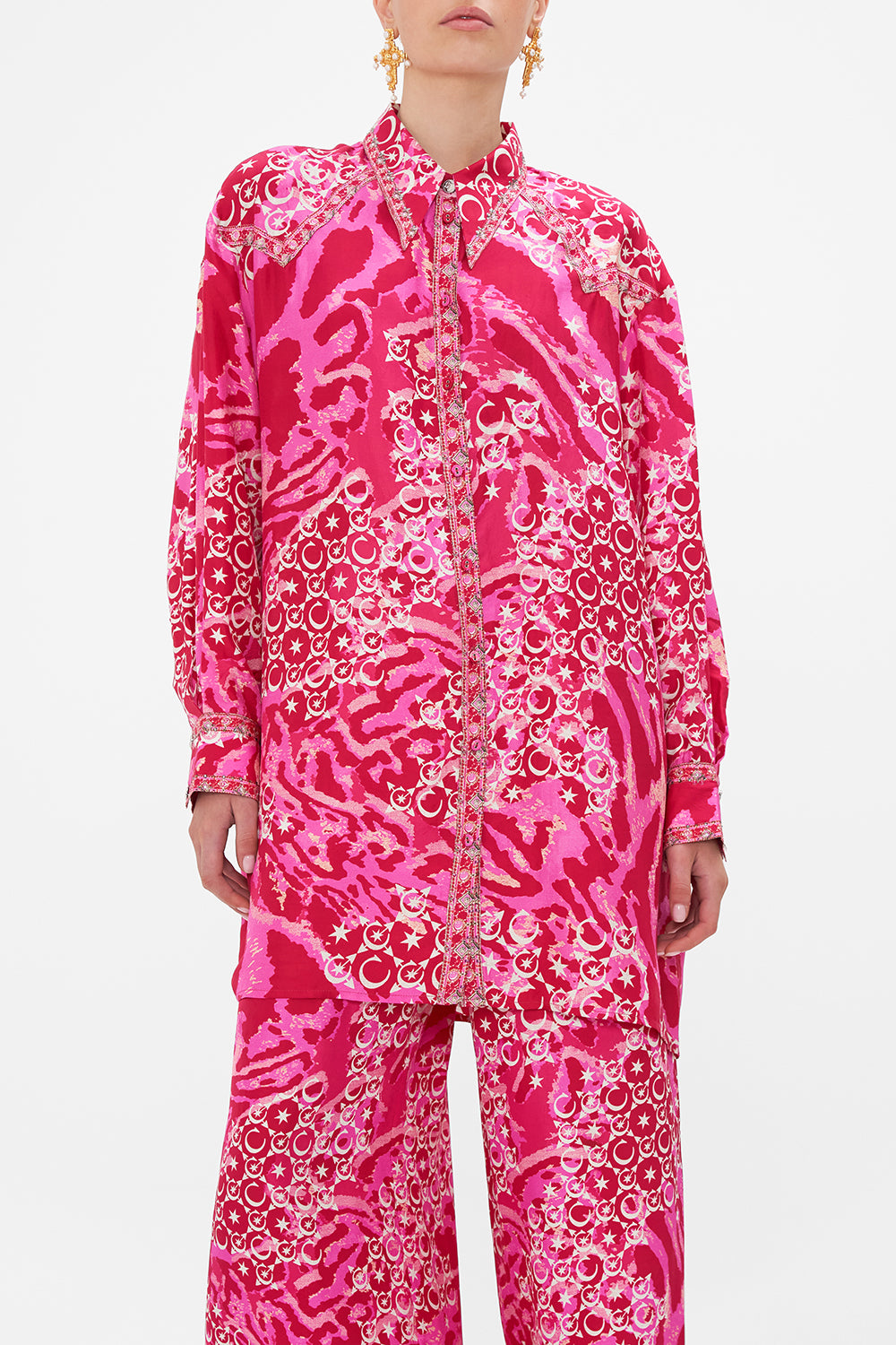 Crop view of model wearing CAMILLA silk shirt in Song Of Sacrifice print