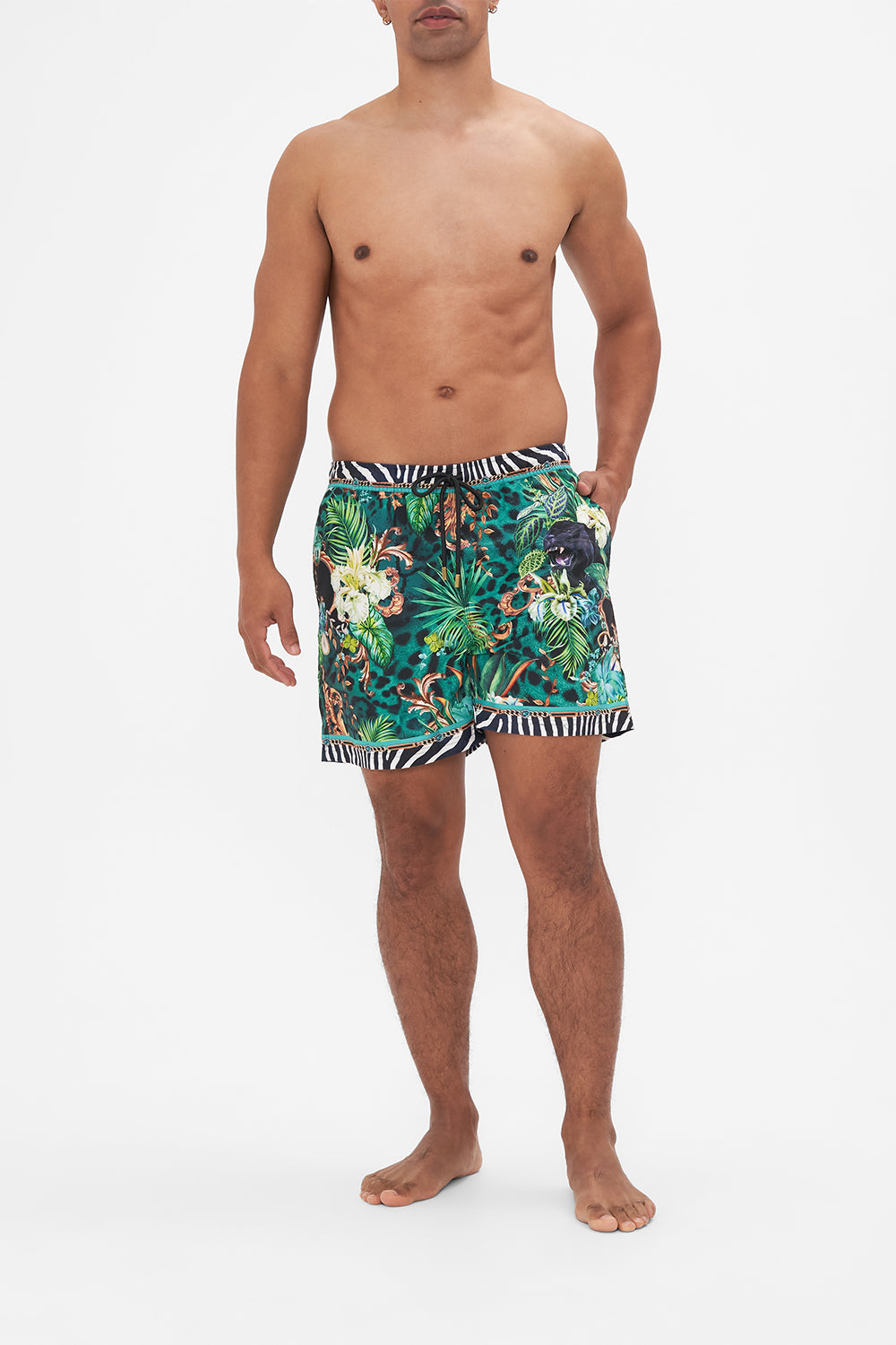 Front view of model wearing Hotel Franks by CAMILLA mens green boardshorts in Sing my Song print