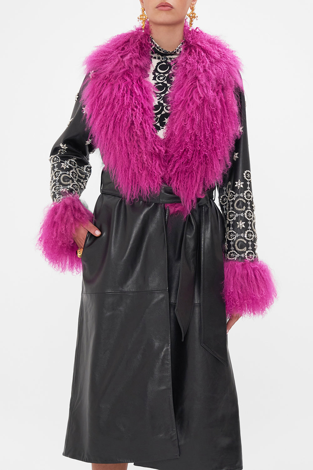 Crop view of model wearing CAMILLA black leather trench with fur cuffs and collar
