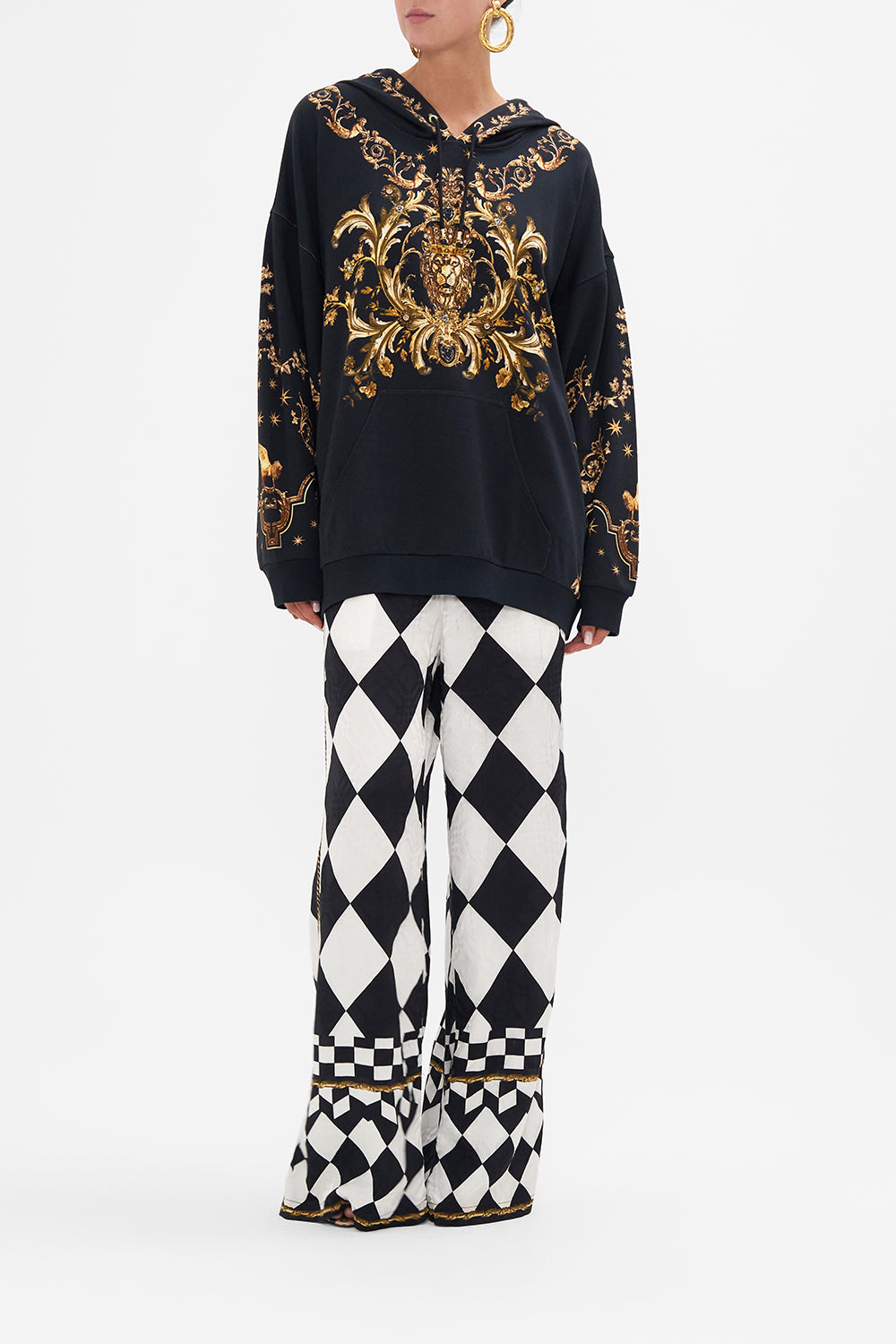 Front view of model wearing CAMILLA black and gold printed hoodie in Duomo Dynasty print