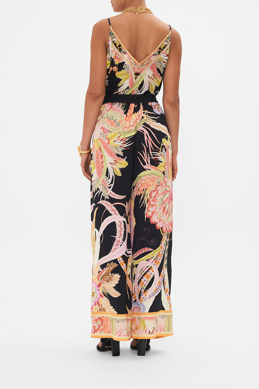 Back view of model wearing CAMILLA designer wide leg pants in Lady of The Moon print