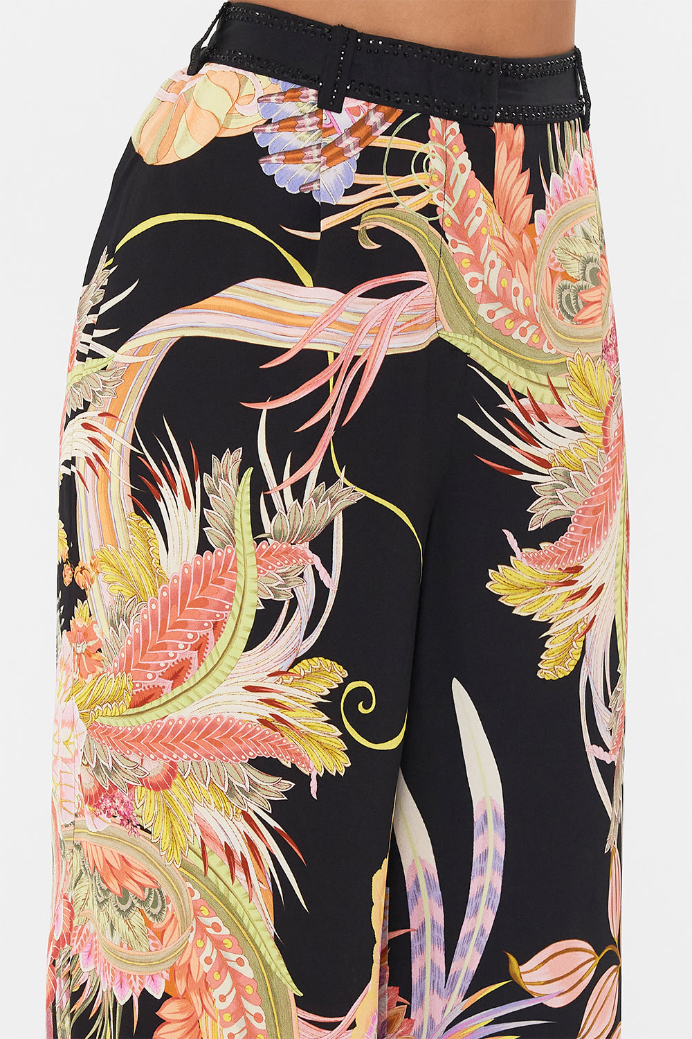 Detail view of model wearing CAMILLA designer wide leg pants in Lady of The Moon print