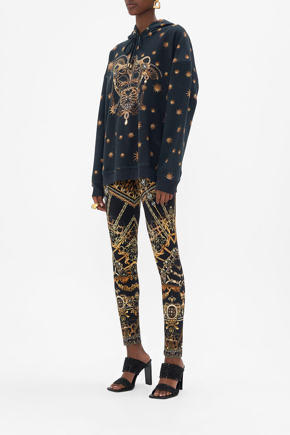 Side view of model wearing CAMILLA luxury hoody in Masked At Moonlight print