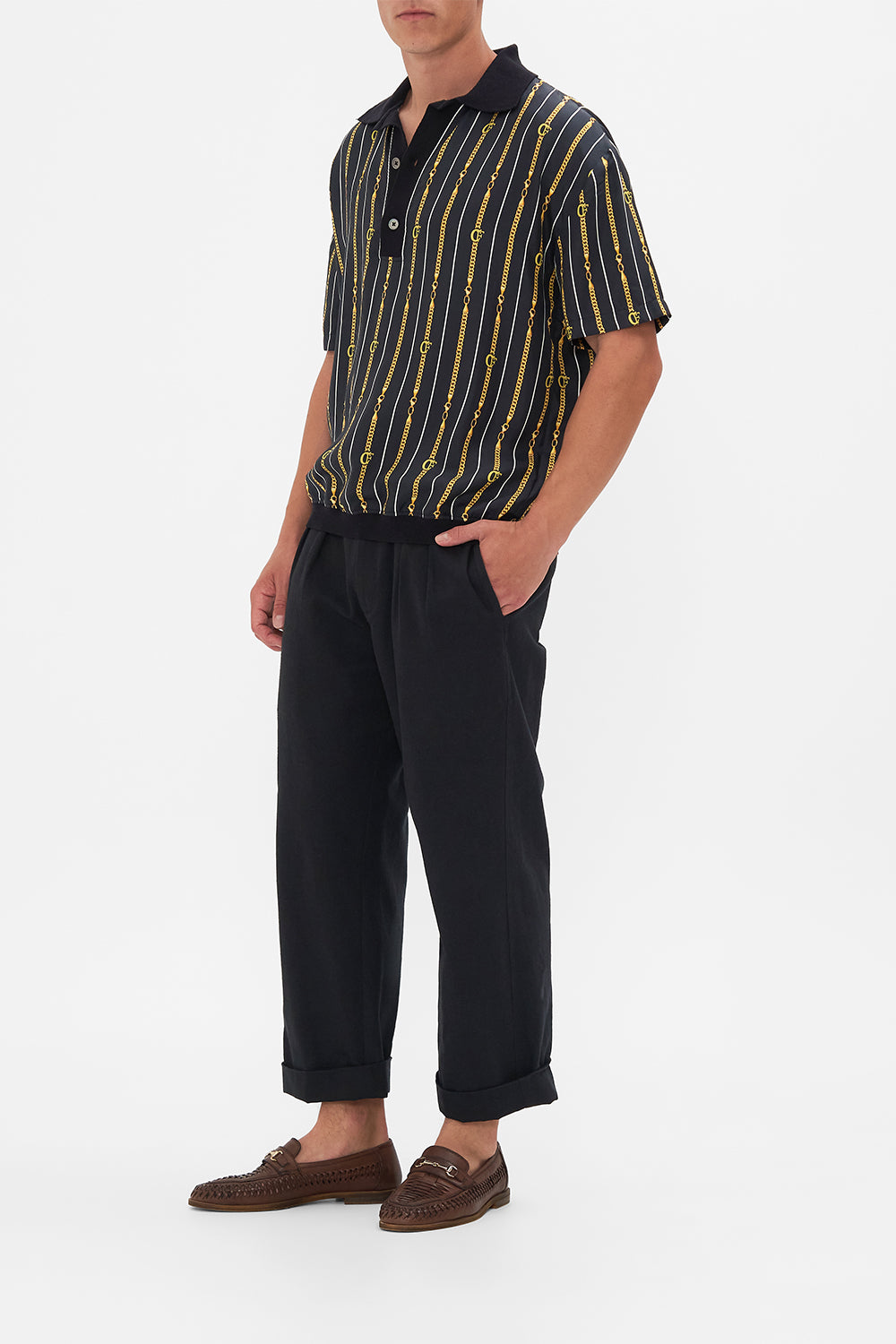 Side view of model wearing Hotel Franks by CAMILLA mens shirt sleeve polo shirt in Coast to Coast print