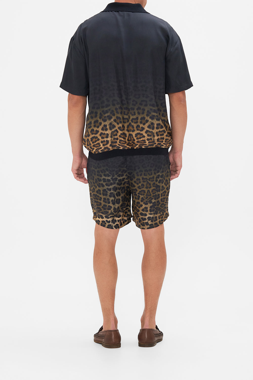 Back view of model wearing Hotel Franks By CAMILLA mens polo shirt in Masked At Moonlight print