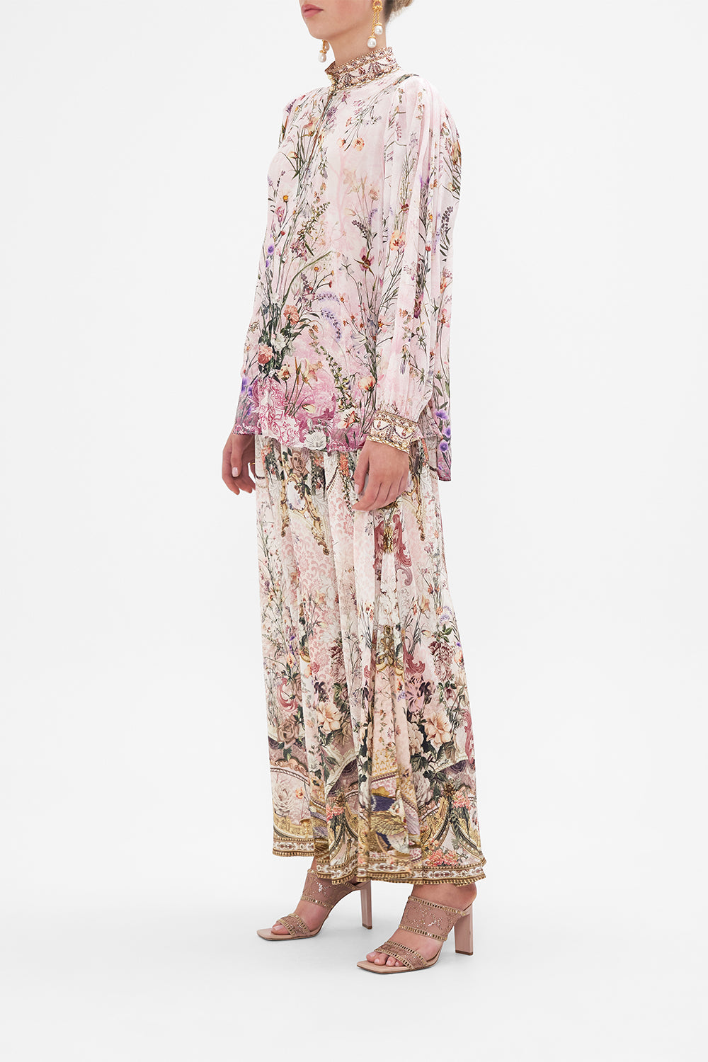 Side view of model wearing CAMILLA floral slik blouse in Kissed By The Prince print