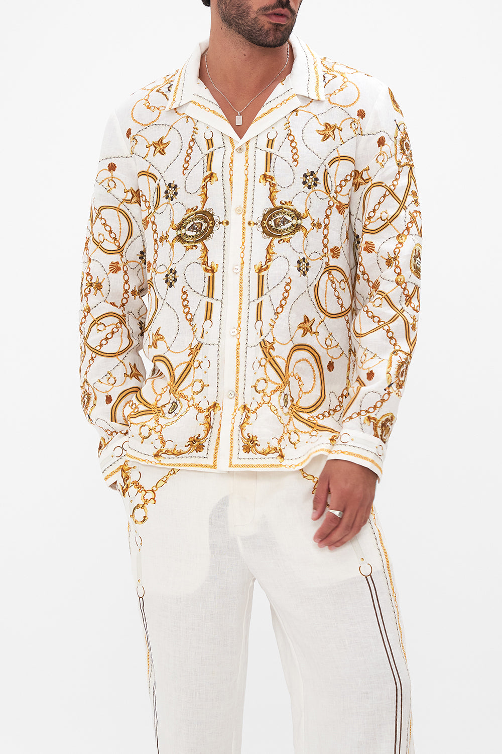 Crop view of model wearing Hotel Franks By CAMILLA mens long sleeve camp collared shirt in Coast To Coast print