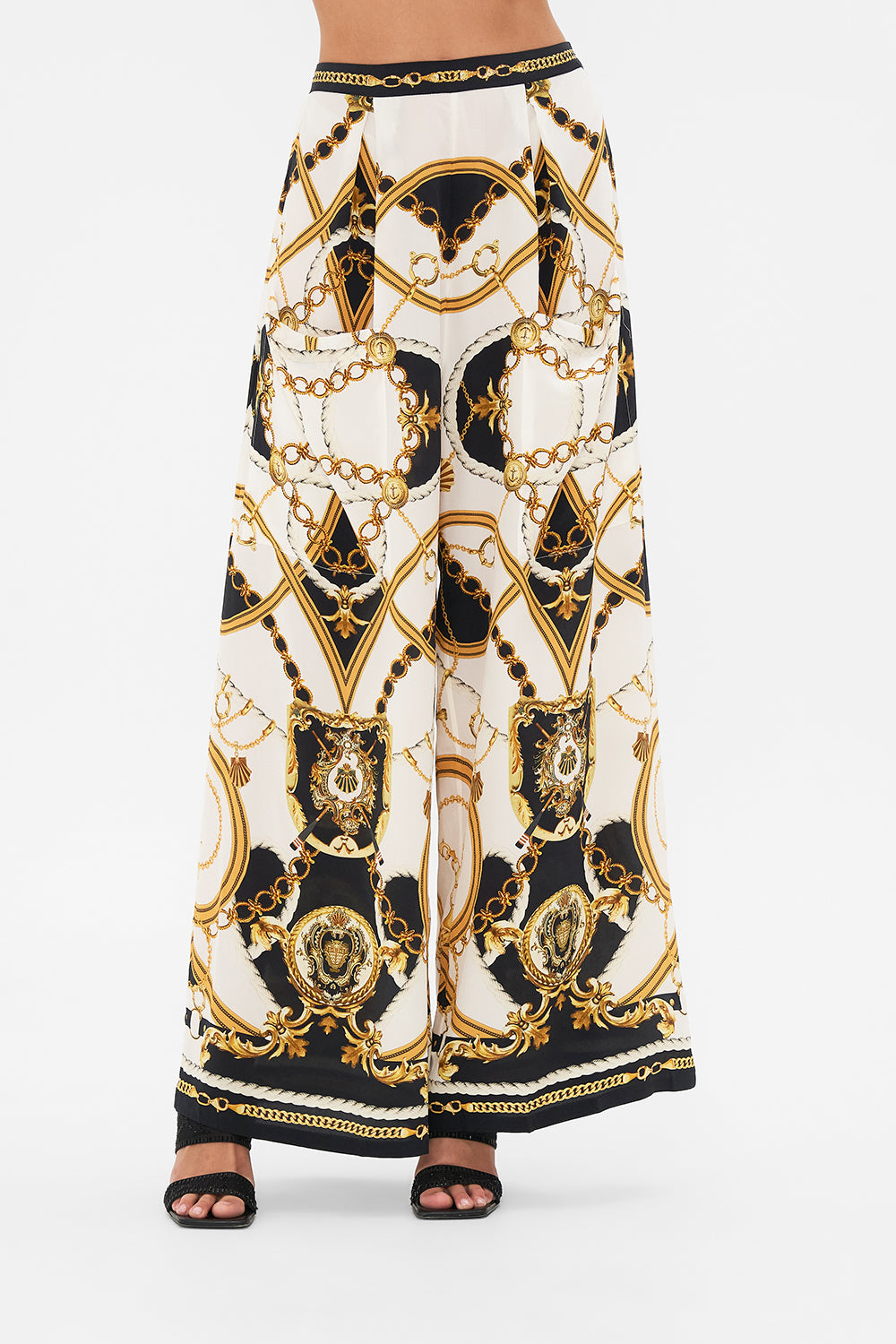 Crop view of model wearing CAMILLA silk palazzo pants in Sea Charm print