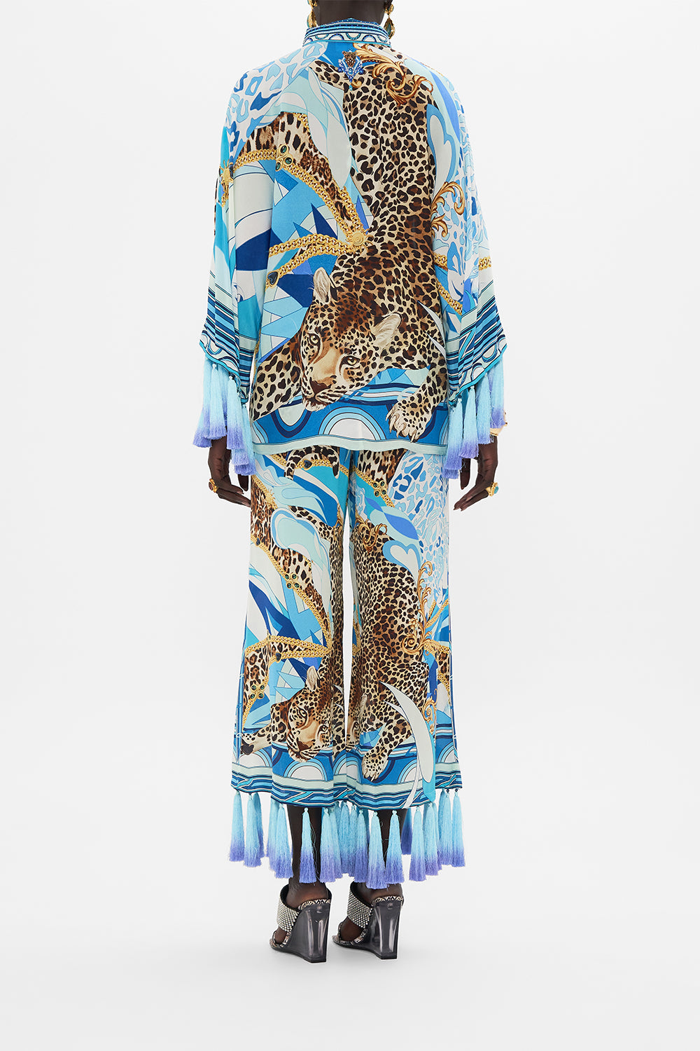 Back view of model wearing CAMILLA silk blouse in Sky Cheetah print