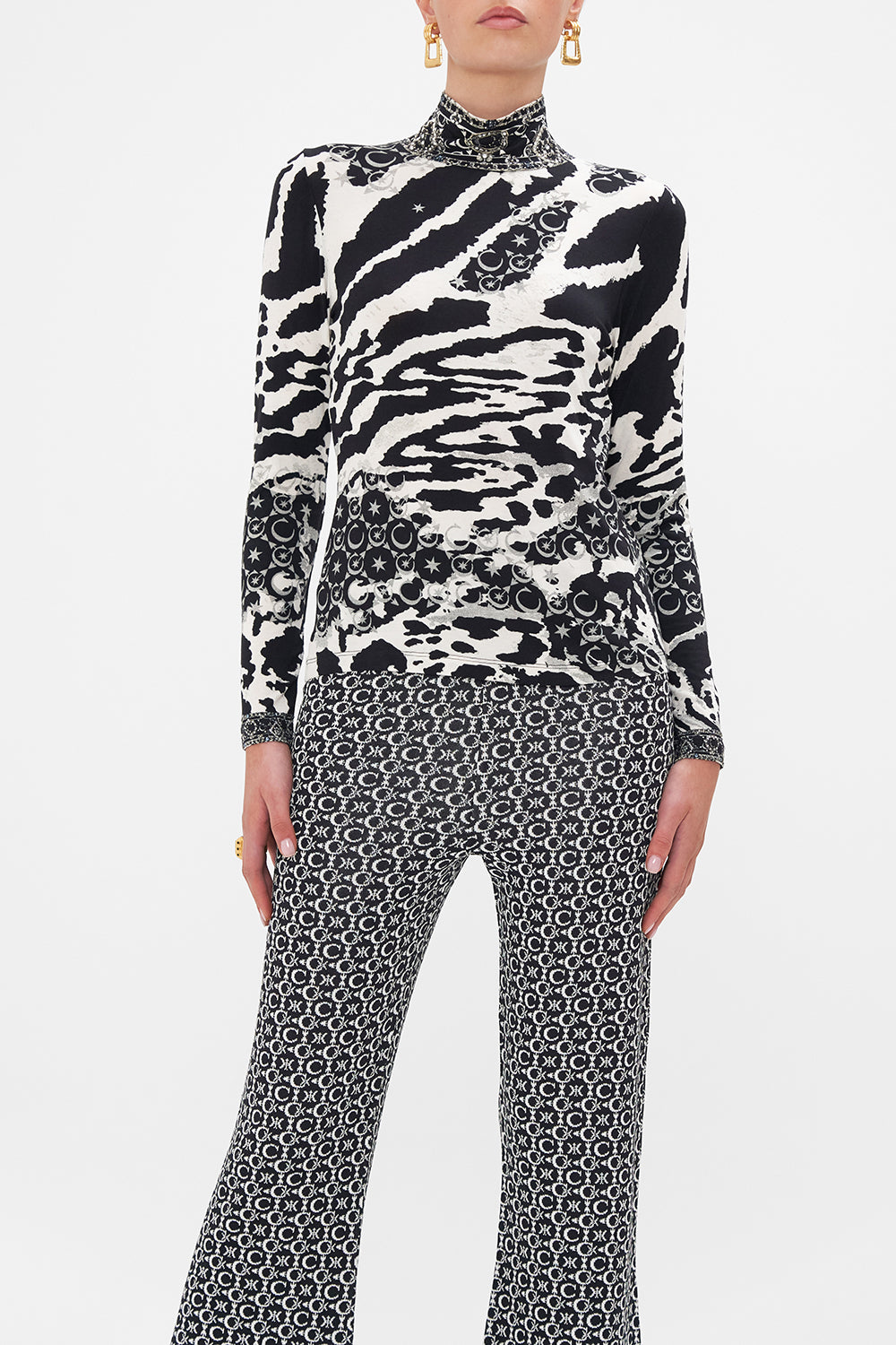 Crop view of model wearing CAMILLA turtleneck top in black and white Feline Fantasy print