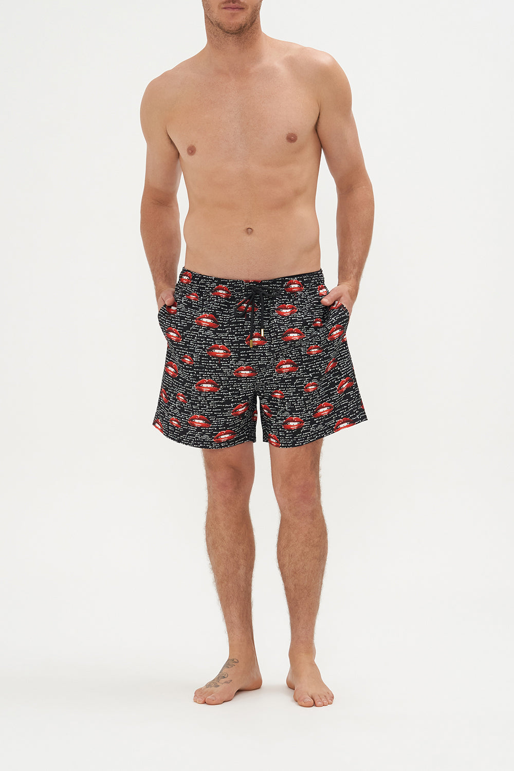 Front view of model wearing Hotel Franks by CAMILLA mens elastic waist boardshorts in black Chaos Magic Print
