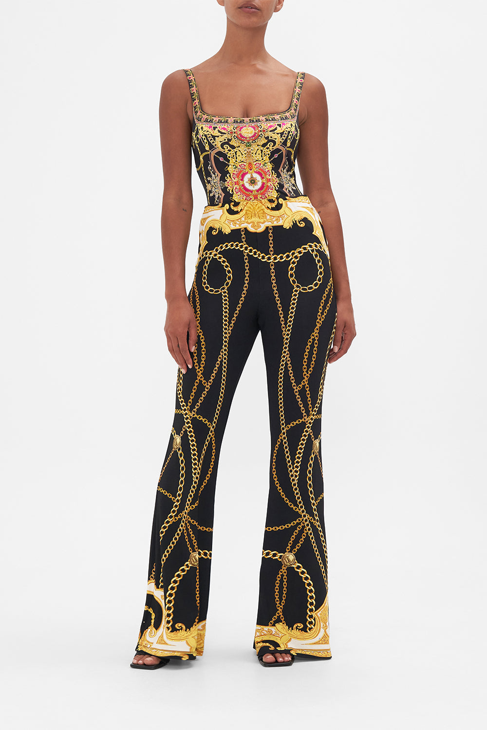 Front view of model wearing CAMILLA black flared pants in Tether Me Not print