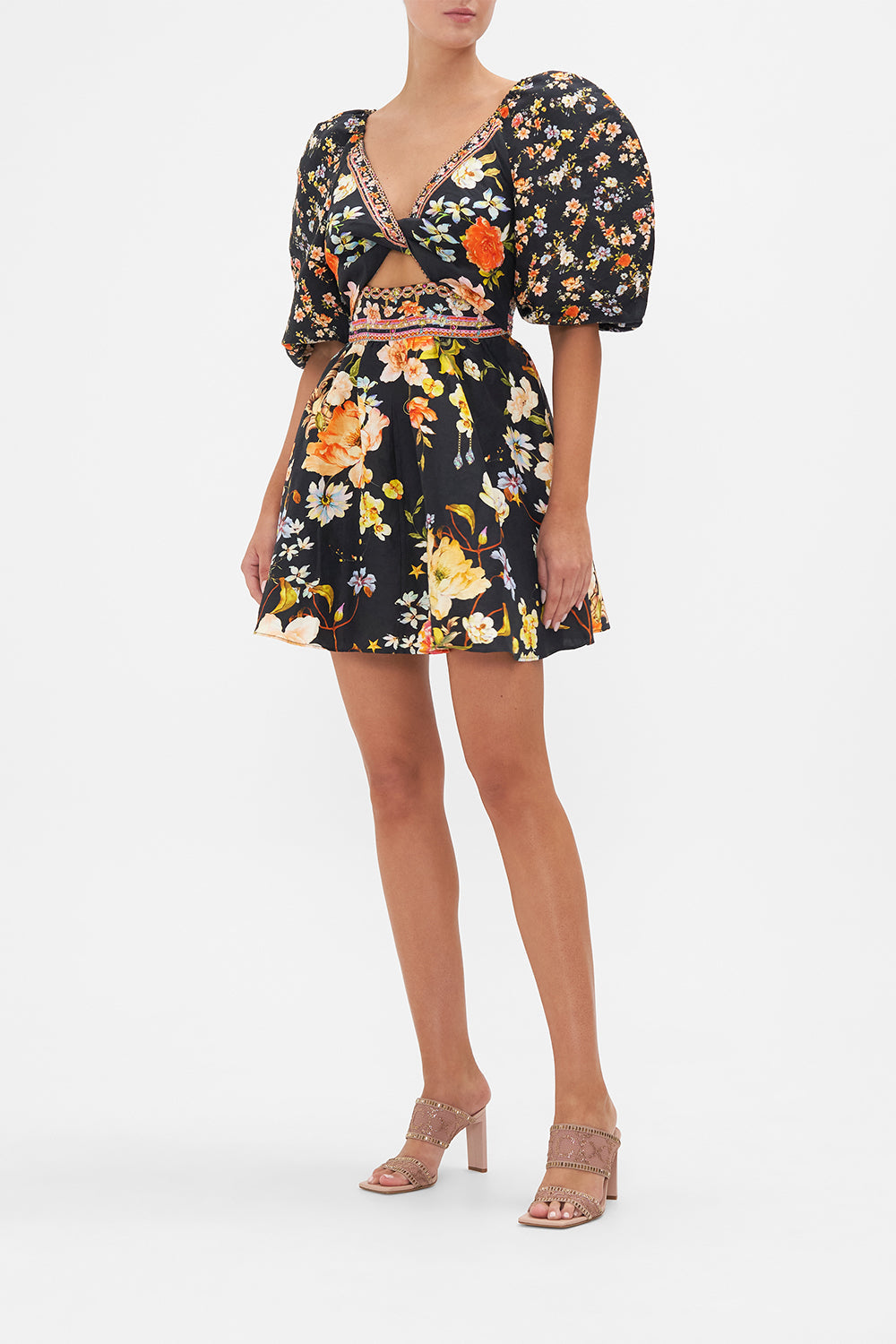 Side view of model wearing CAMILLA floral mini dress in Secret History print