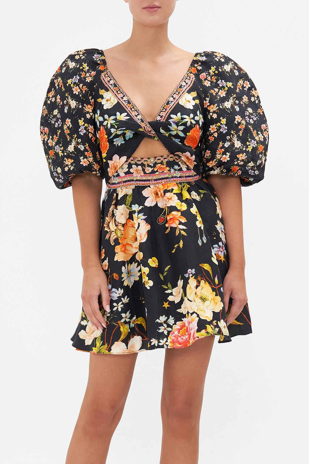 Crop view of model wearing CAMILLA floral mini dress in Secret History print