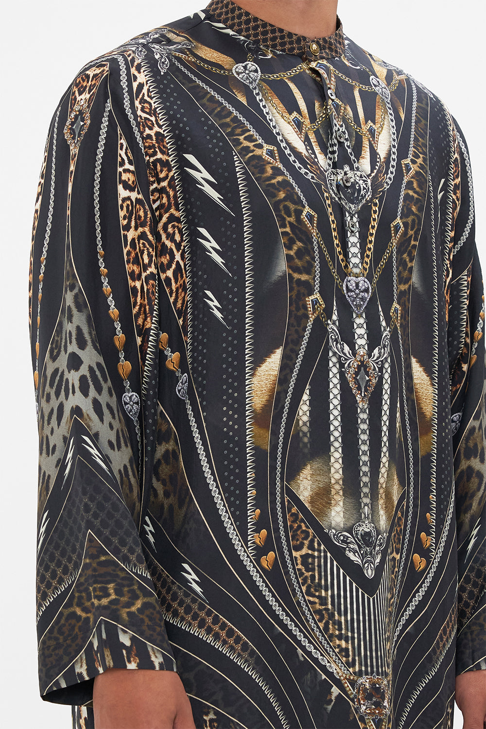 Detail view of model wearing Hotel Franks by CAMILLA mens silk kaftan in Chaos In The Cosmos animal print 