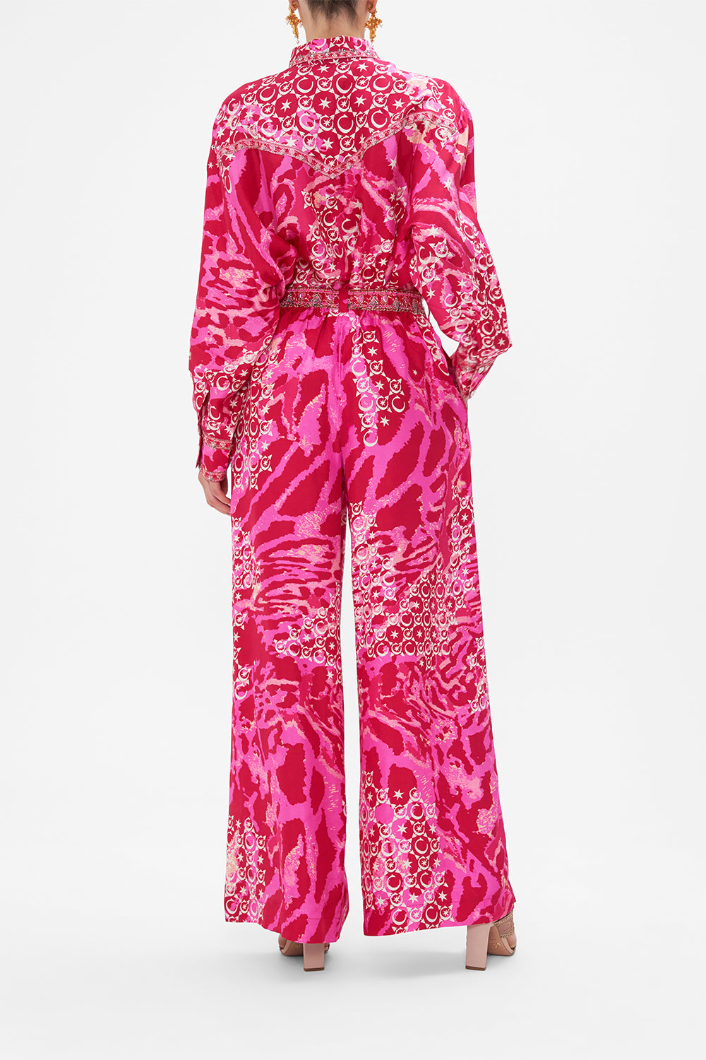 Back view of model wearing CAMILLA silk palazzo pants in Song Of Sacrifice print