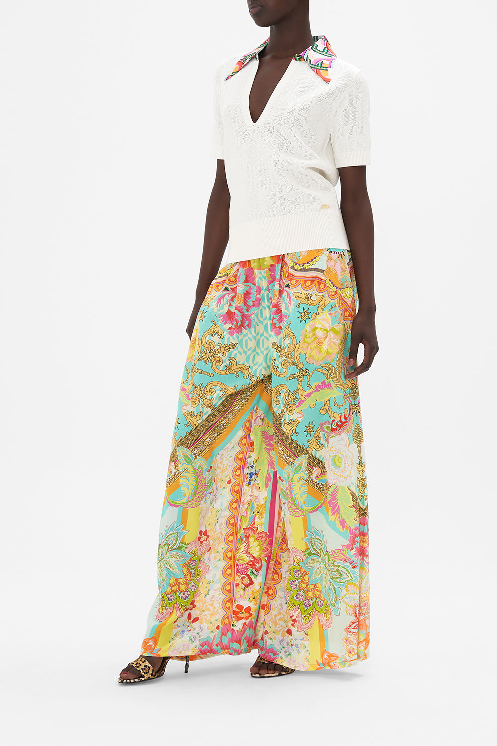 Side view of model wearing CAMILLA white knit polo  top in An Italian Welcome print