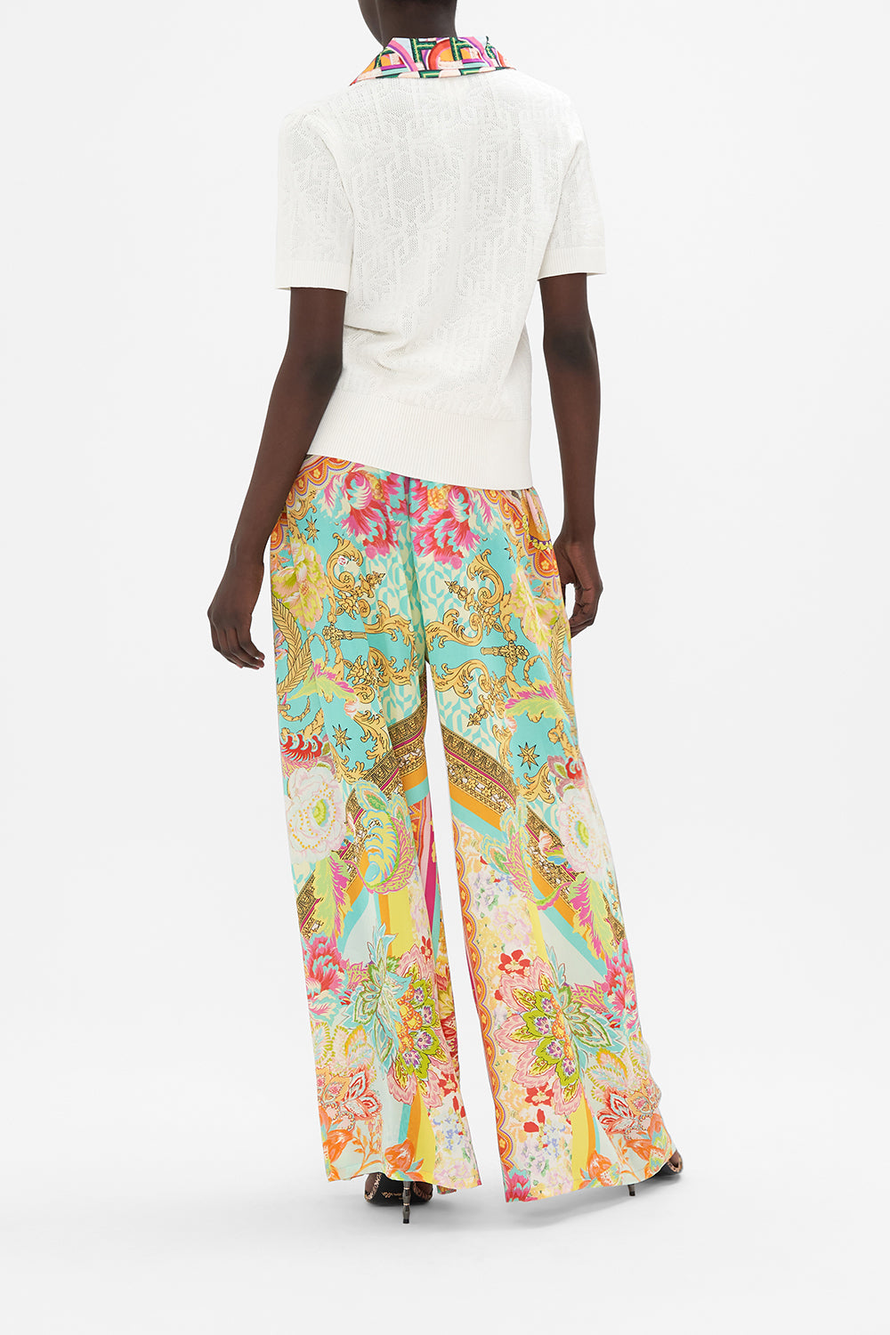 Back view of model wearing CAMILLA white knit polo  top in An Italian Welcome print