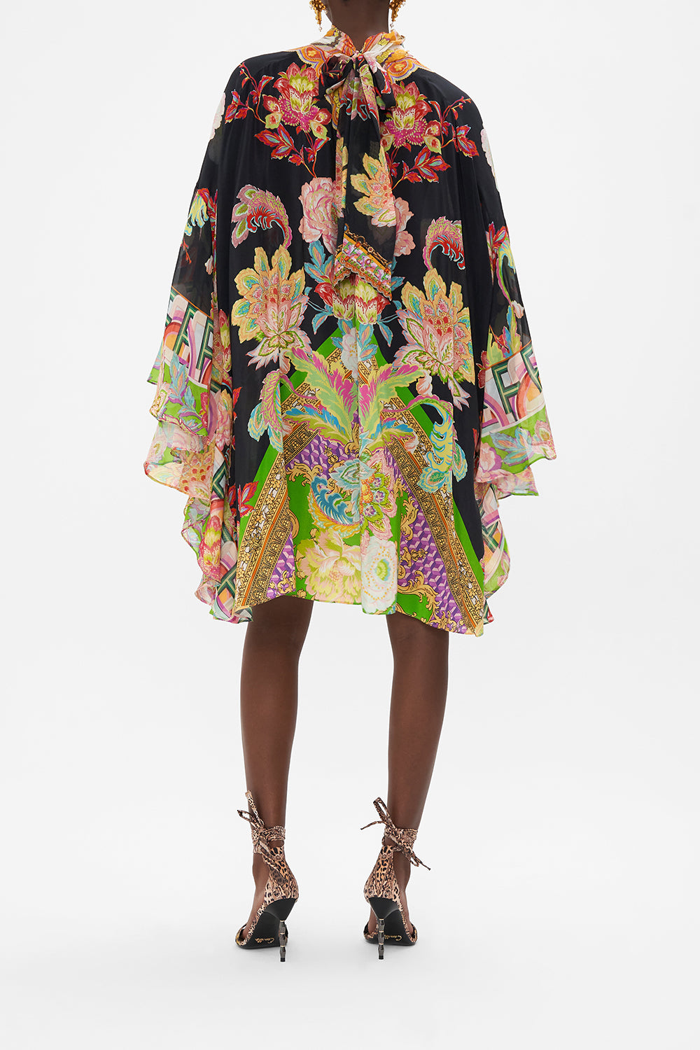 Back view of model wearing CAMILLA silk high neck ruffle dress in Sundowners in Sicily print 
