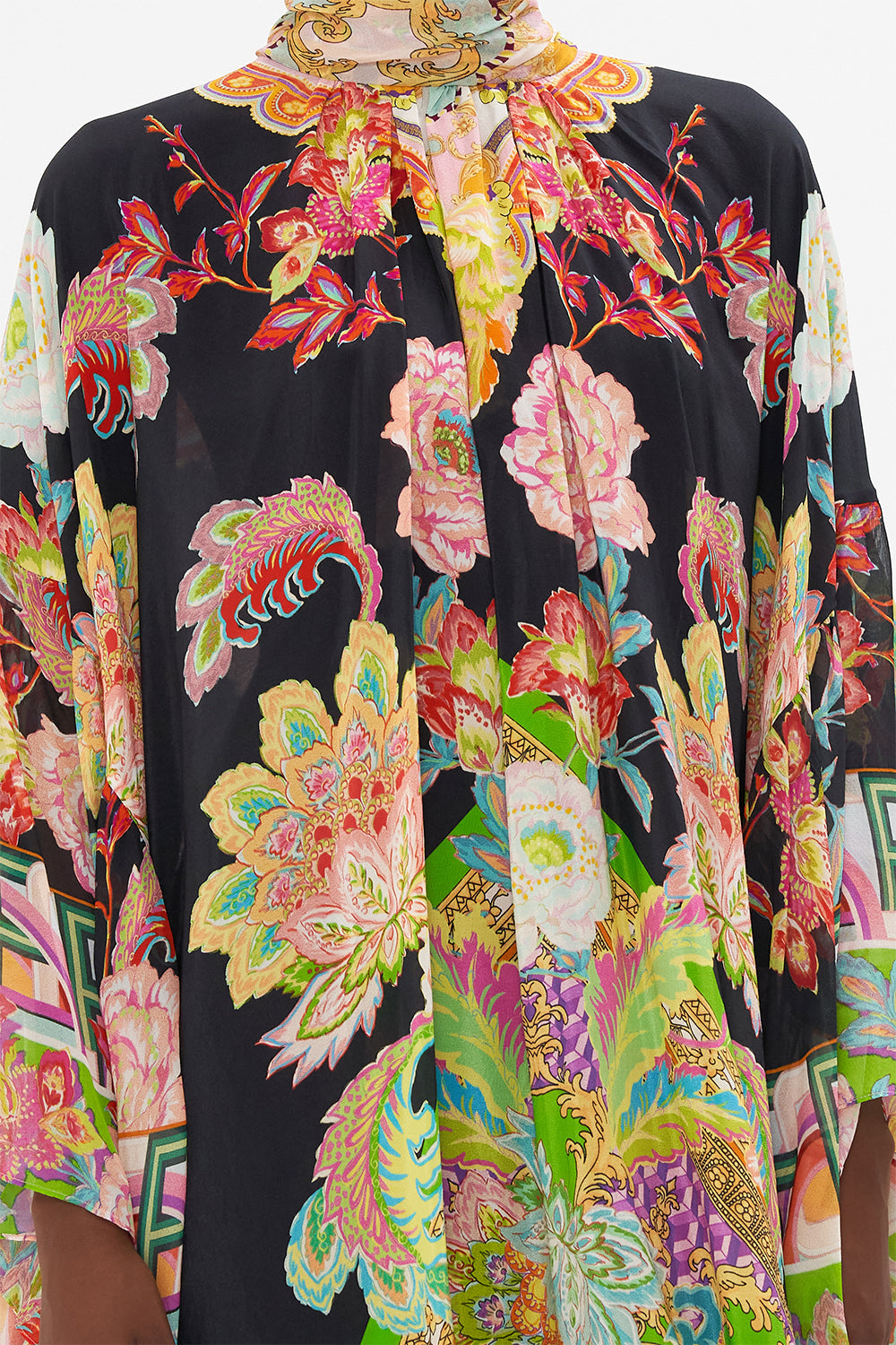 Detail view of model wearing CAMILLA silk high neck ruffle dress in Sundowners in Sicily print 