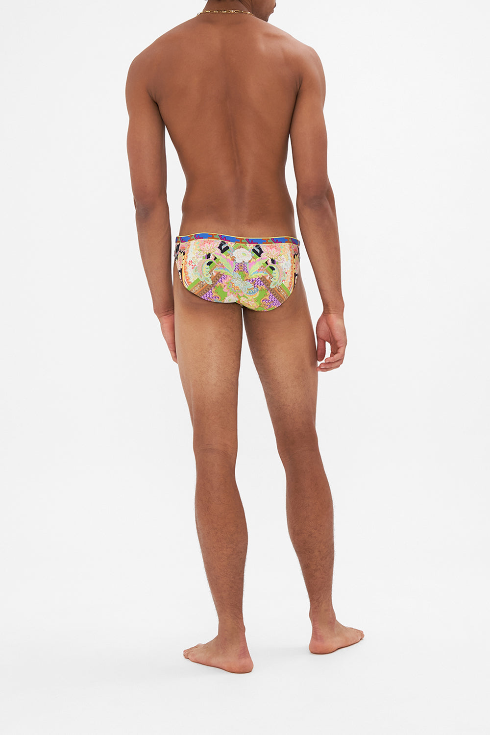 Back view of model wearing HOTEL FRANKS BY CAMILLA mens swim in Sundowners in Sicily print 