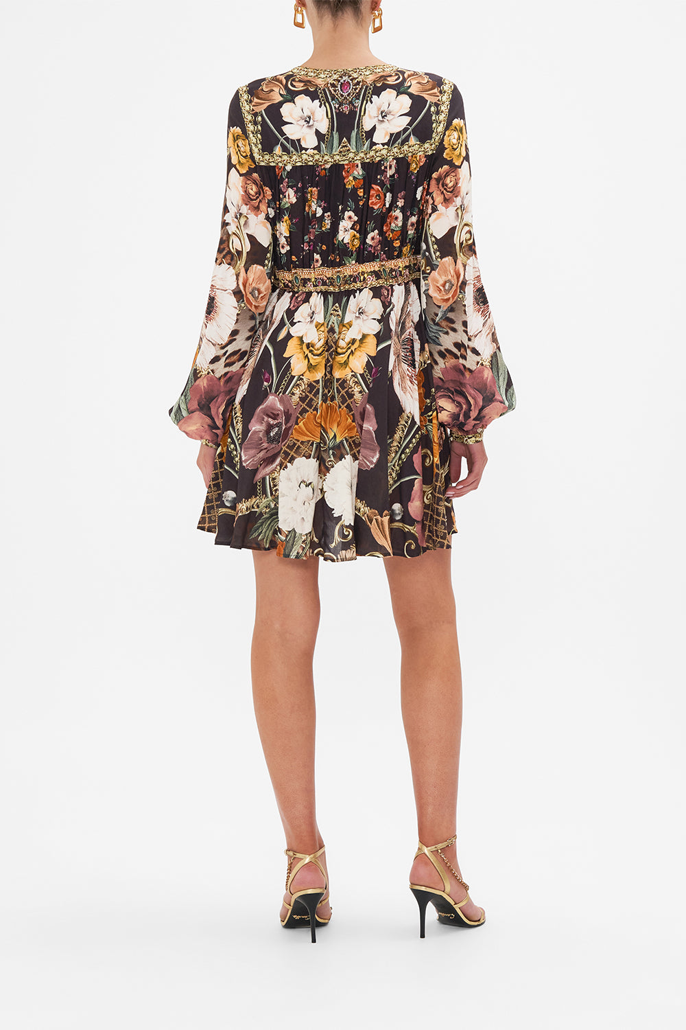 Back view of model wearing CAMILLA brown floral mini dress in Wave Your Wand print