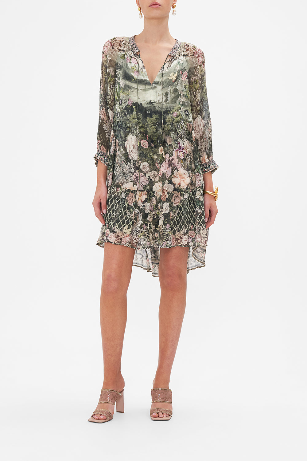 Front view of model wearing CAMILLA green floral mini dress in Garden Of Good Fortune print