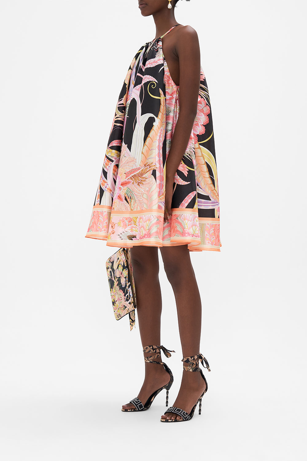 Side view of model wearing CAMILLA trapeze mini dress in Lady of The Moon print