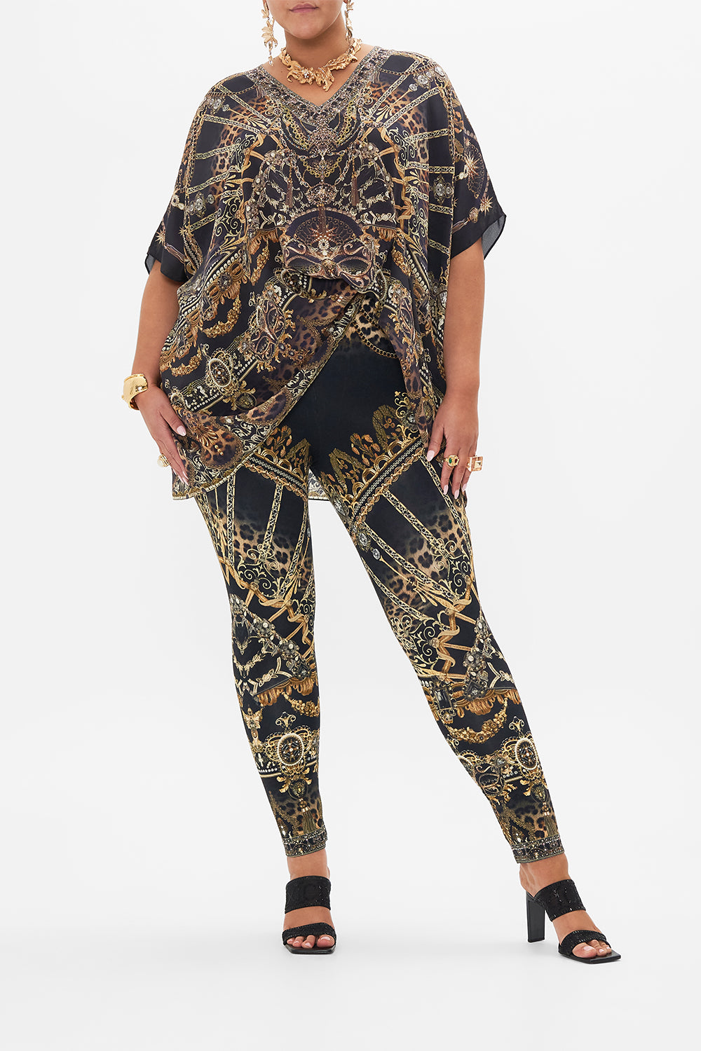 Front view of curvy model wearing CAMILLA plus size leggings in Masked At Moonlight print