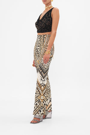 Side view of model wearing CAMILLA flare pant in Mosaic Muse print