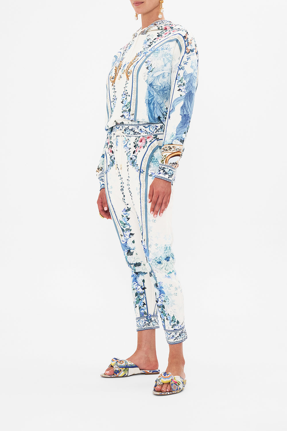 Side view of model wearing CAMILLA designer pants in Season Of The Siren print 