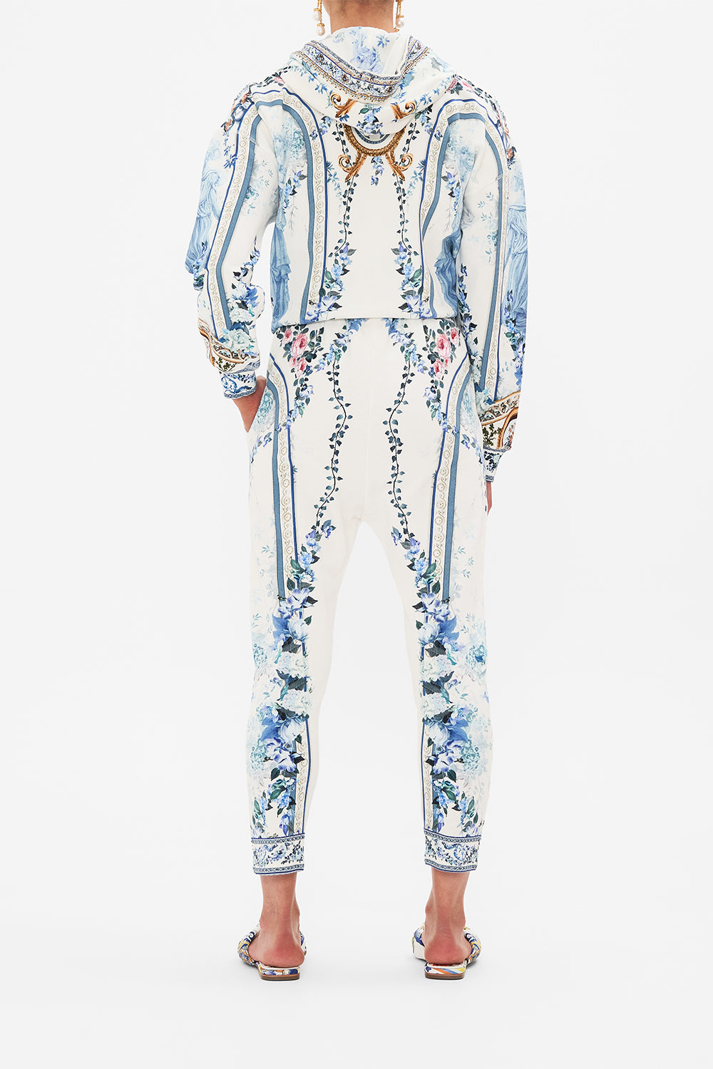 Back view of model wearing CAMILLA designer pants in Season Of The Siren print 