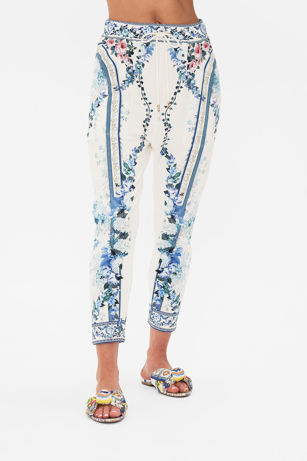 Crop view of model wearing CAMILLA designer pants in Season Of The Siren print 