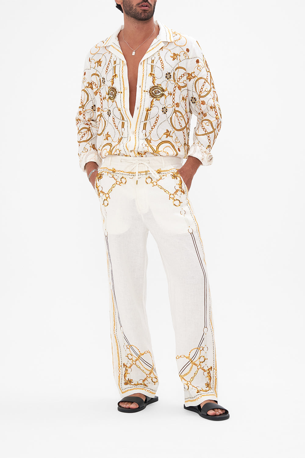 Front view of model wearing Hotel Franks By CAMILLA mens linen pants in Coast to Coast print