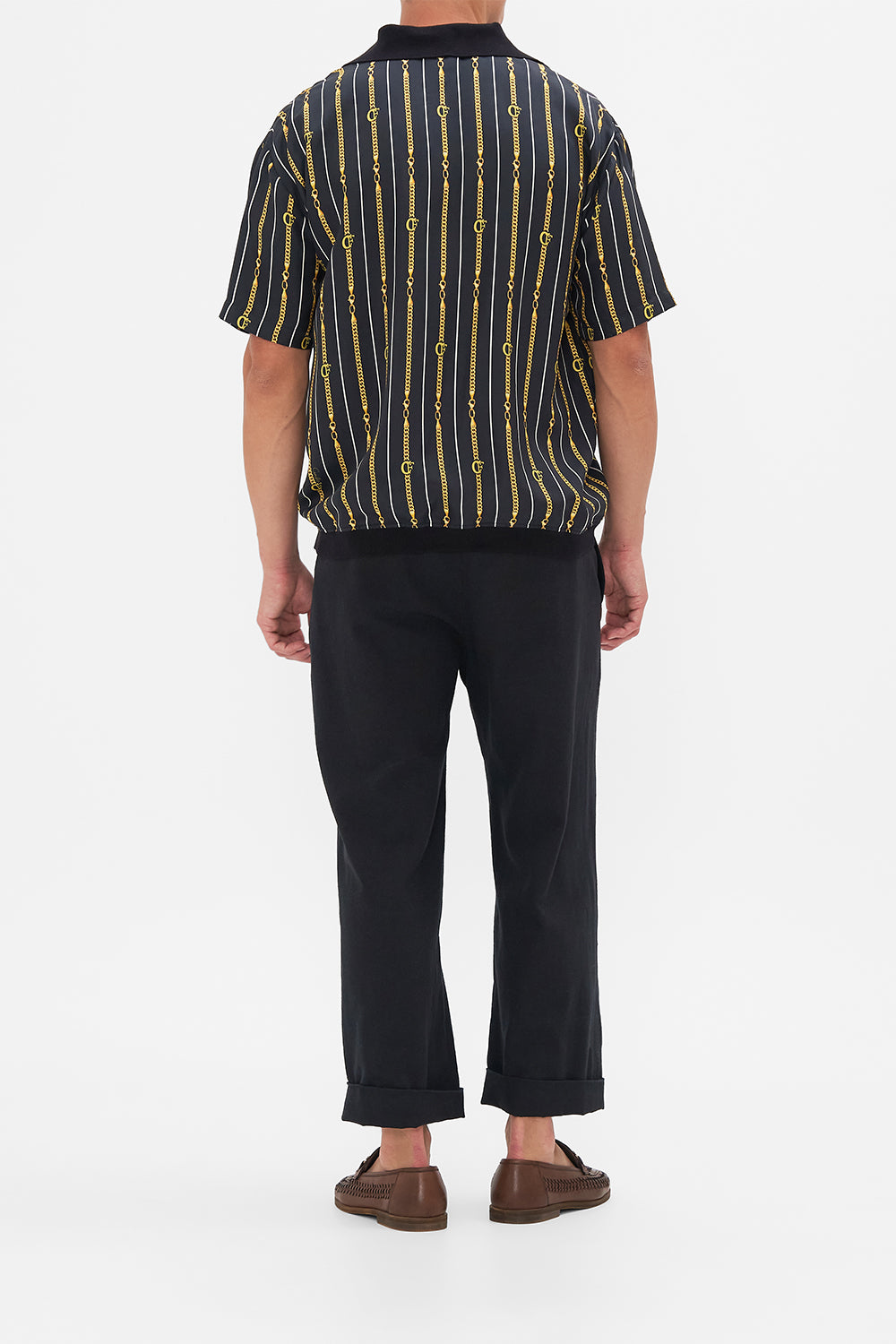 Back view of model wearing Hotel Franks by CAMILLA mens shirt sleeve polo shirt in Coast to Coast print 