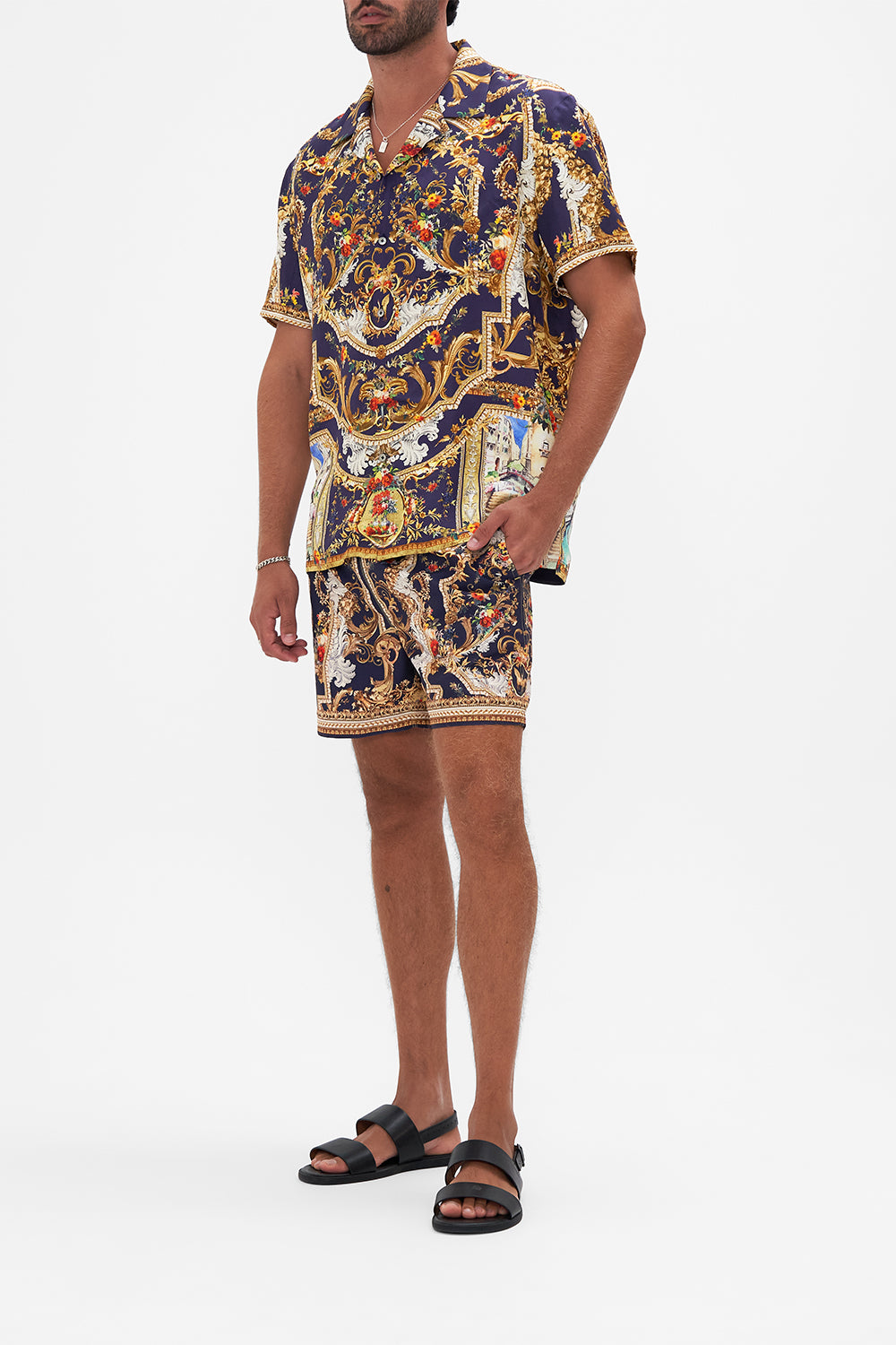 Side view of model wearing Hotel Franks By CAMILLA mens short sleeve camp collared shirt in  Venice Vignette print 