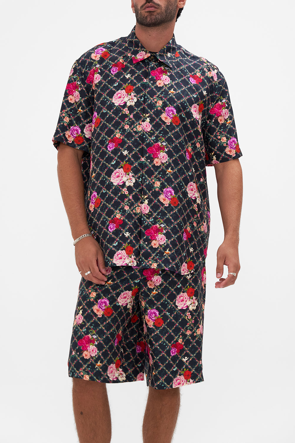 Crop view of model wearing CAMILLA silk short sleeve shirt in Reservation For Love print 