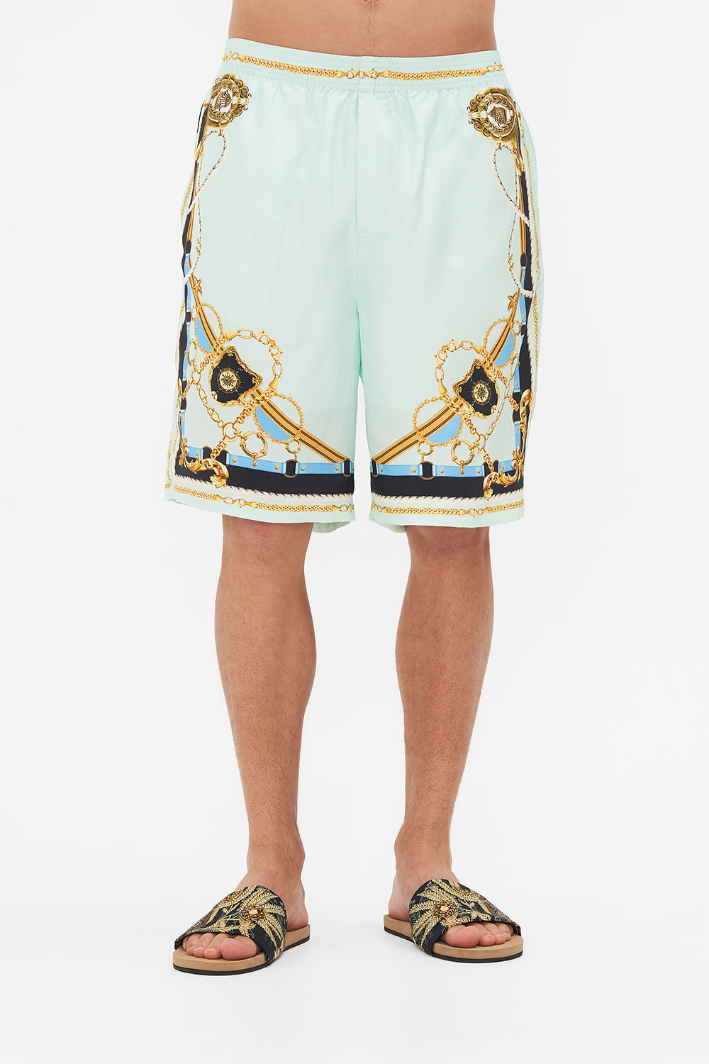 Crop view of model wearing Hotel Franks By CAMILLA mens walk short in Sea Charm print 
