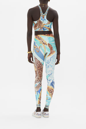 Back view of model wearing CAMILLA activewear crop top in Sky Cheetah print