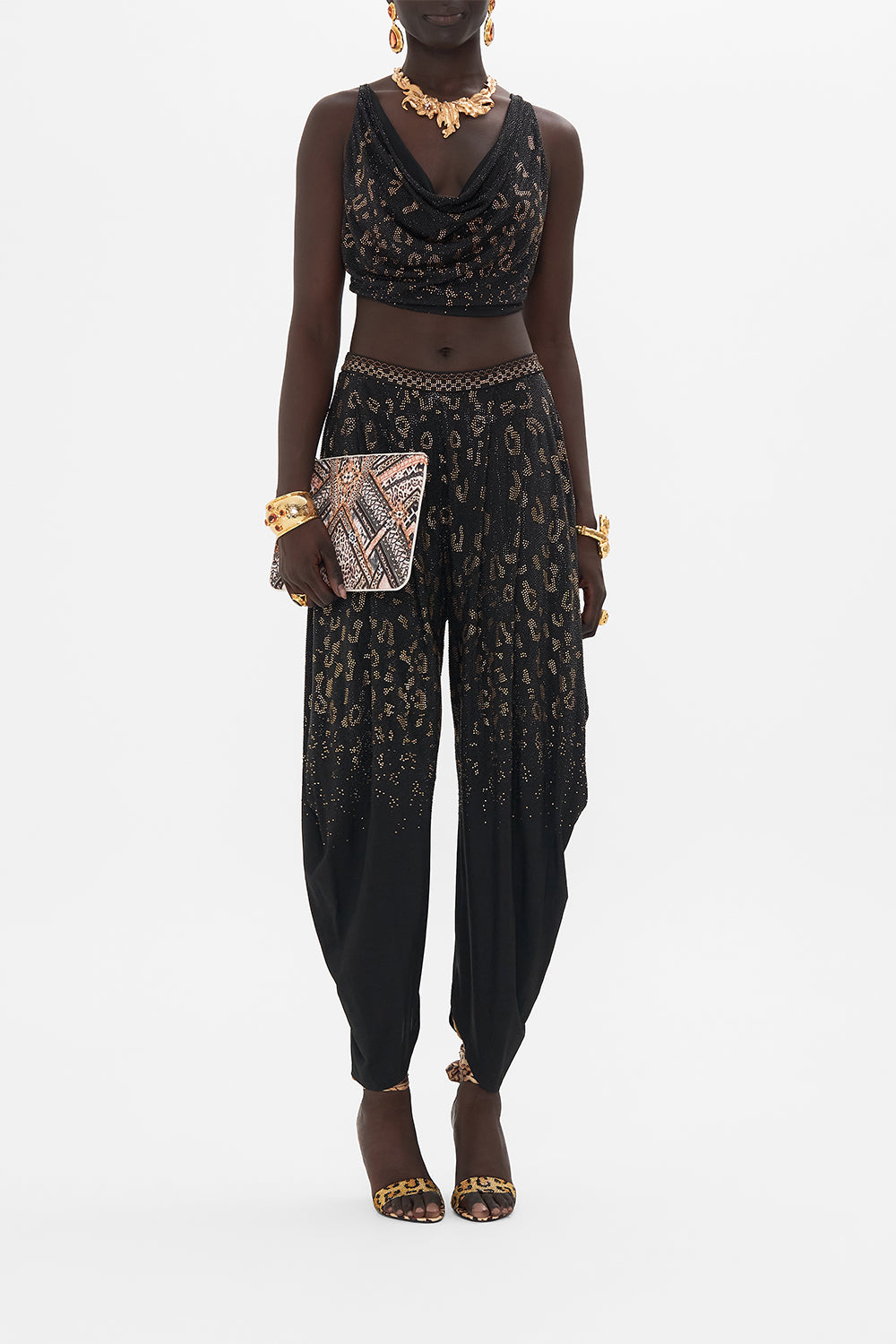 Front view of model wearing CAMILLA black jersey pants in Mosaic Muse print