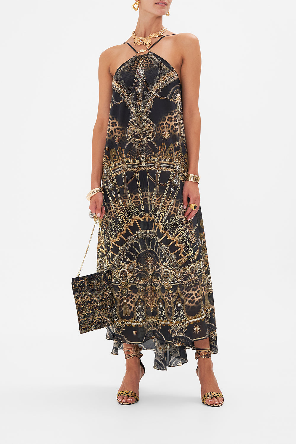Front view of model wearing CAMILLA designer halterneck maxi dress in masked At Moonlight print