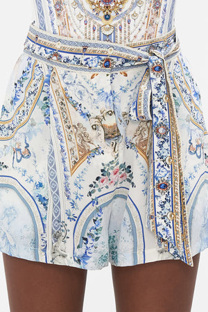 Detail view of model wearing CAMILLA designer silk shorts in Season Of The Siren print