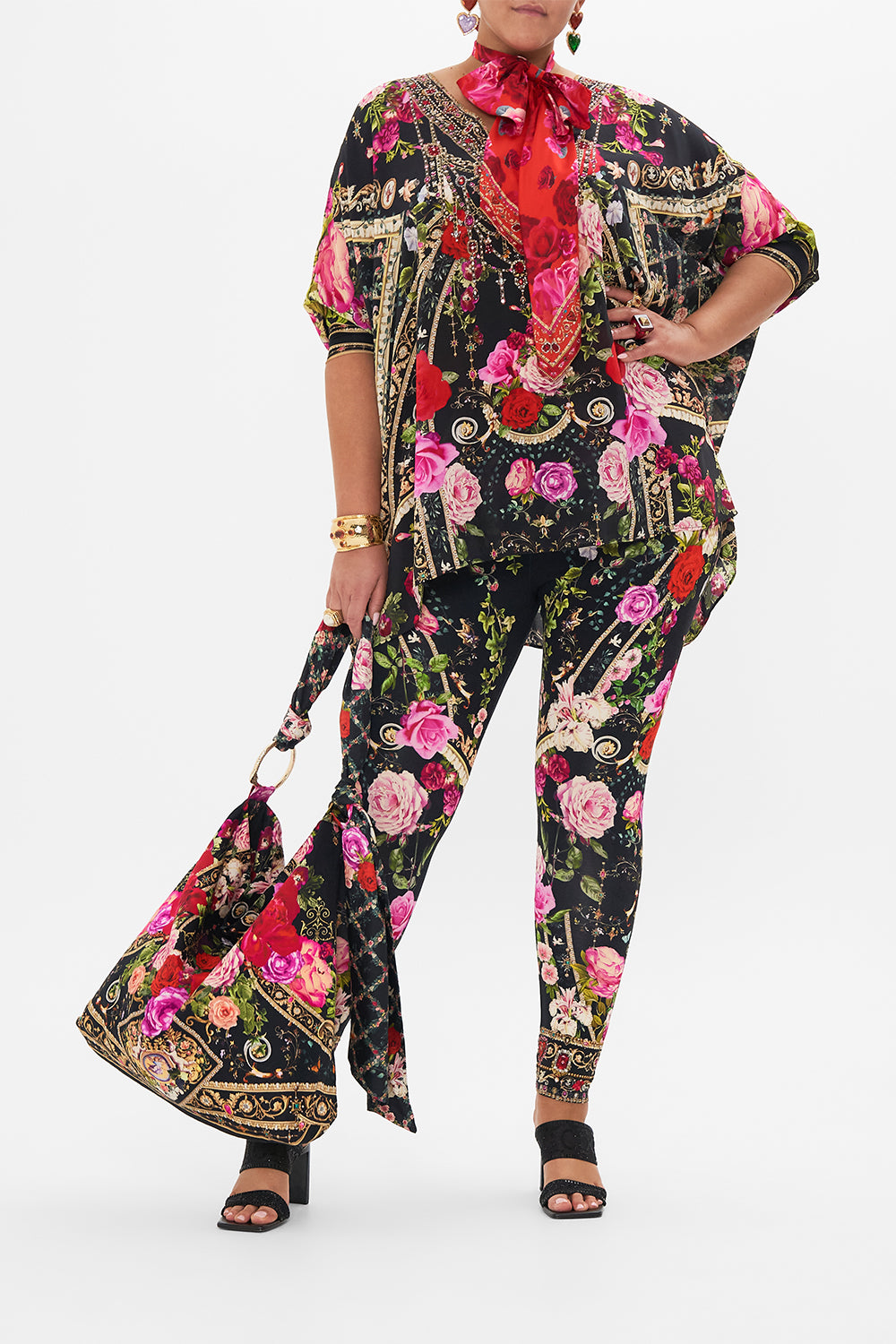Front view of curvy model wearing CAMILLA plus size floral leggings in Reservation For love print 