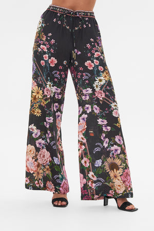 Crop view of model wearing CAMILLA linen lounge pant in Letters From A Vineyard print 
