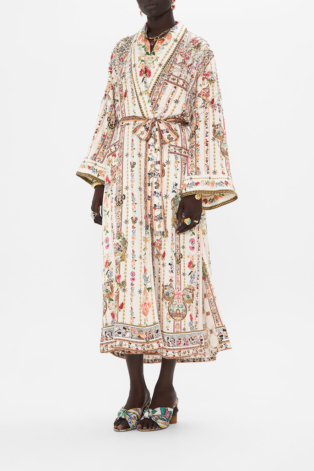 Side view of model wearing Disney x CSAMILLA silk robe in Minnie Magic Forever print 