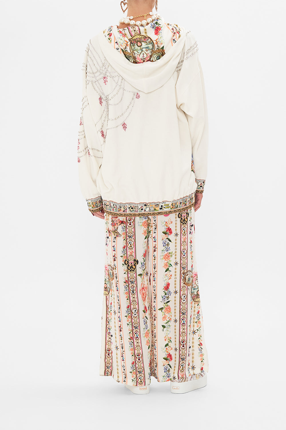 Back view of model wearing Disney x CAMILLA hoodie in Minnie Magic Forever print