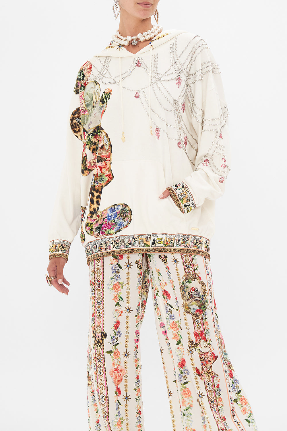 Crop view of model wearing Disney x CAMILLA hoodie in Minnie Magic Forever print