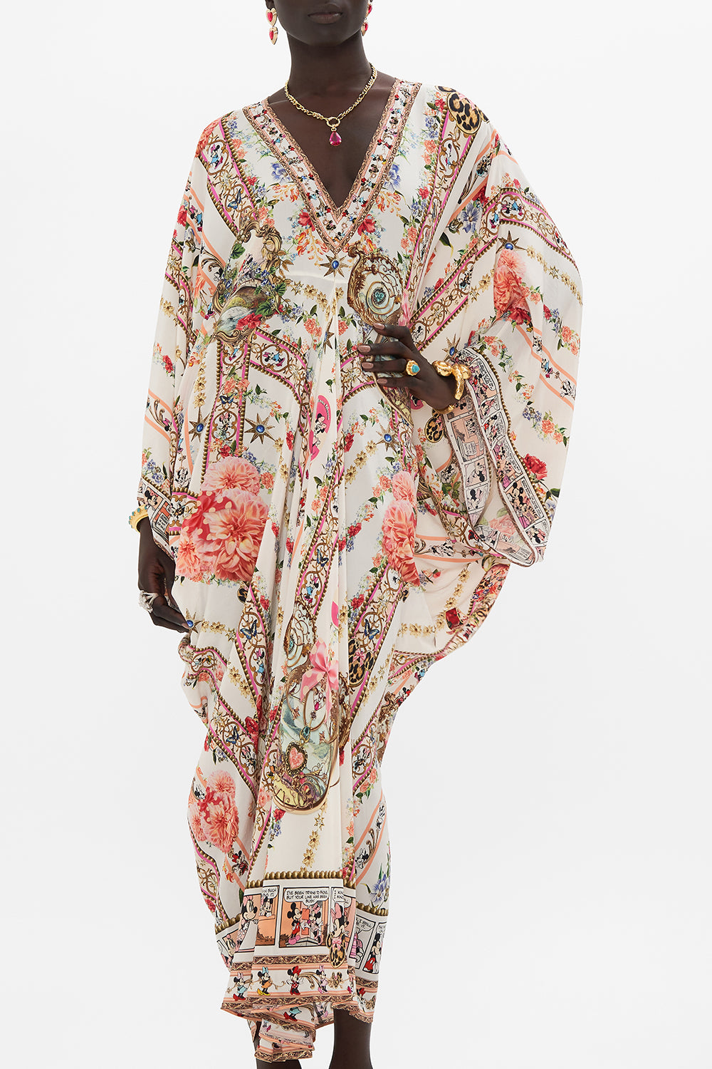 Crop view of model wearing Disney x CAMILLA silk kaftan in Minnie Magic Forever print 