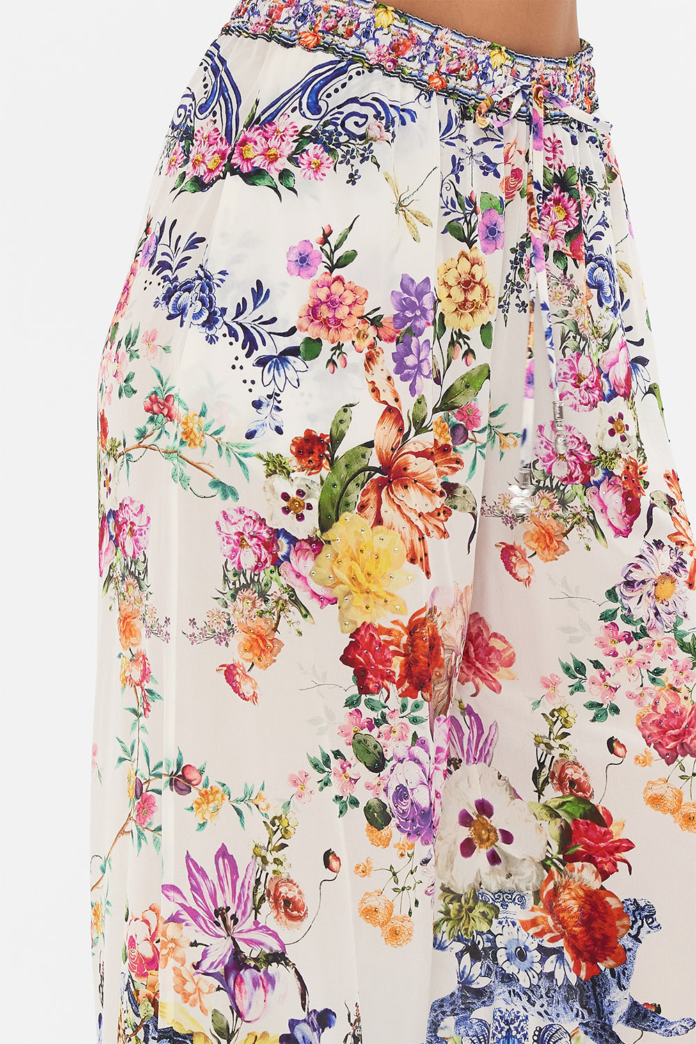 Detail view of model wearing CAMILLA silk pants in Dutch Is Life print