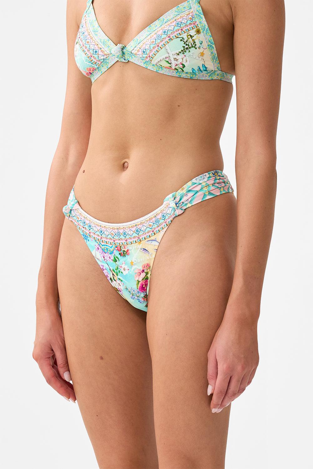 The CAMILLA Regular Bikini Bottom With Ruched Knot Sides in our Just Coasting print.